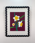 Framed artwork of daffodils on a purple background